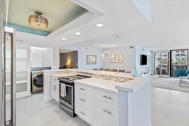 a kitchen with a stove a sink a refrigerator and a stove