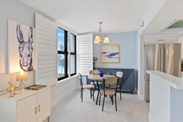 a view of a dining room with furniture and chandelier