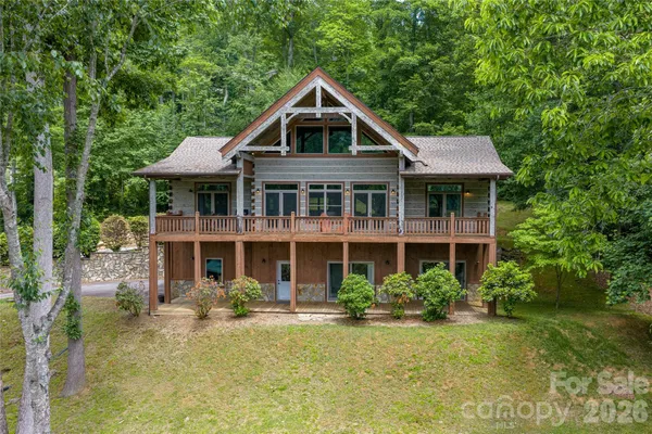 a front view of a house with swimming pool and porch