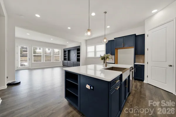a large kitchen with a large counter top and stainless steel appliances