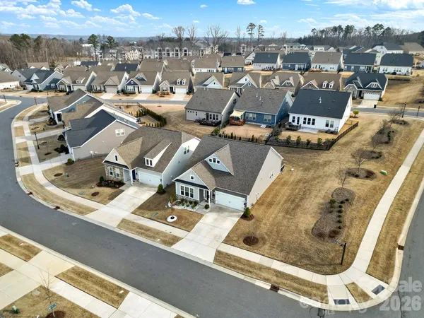 an aerial view of a residential apartment building with parking