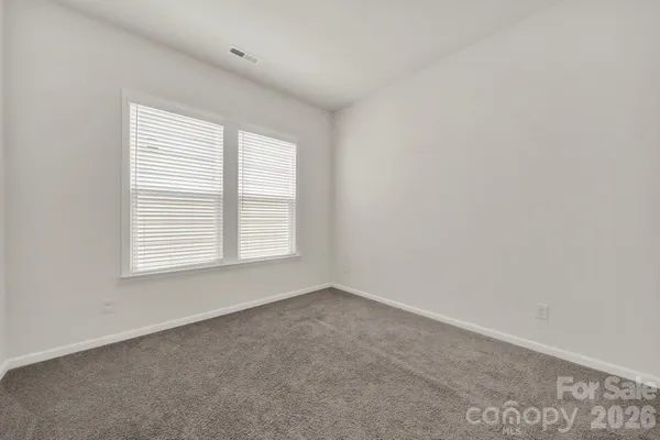 a spacious bathroom with a double vanity sink and a mirror