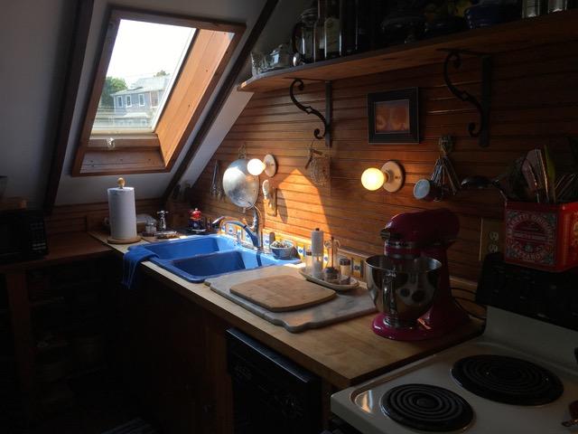 55 Commercial Street Wellfleet, MA 02667 - Photo 13 of 35 a kitchen with stainless steel appliances granite countertop a sink stove and cabinets