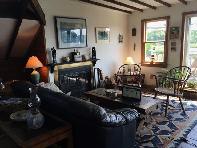 55 Commercial Street Wellfleet, MA 02667 - Photo 17 of 35 a living room with furniture and a fireplace