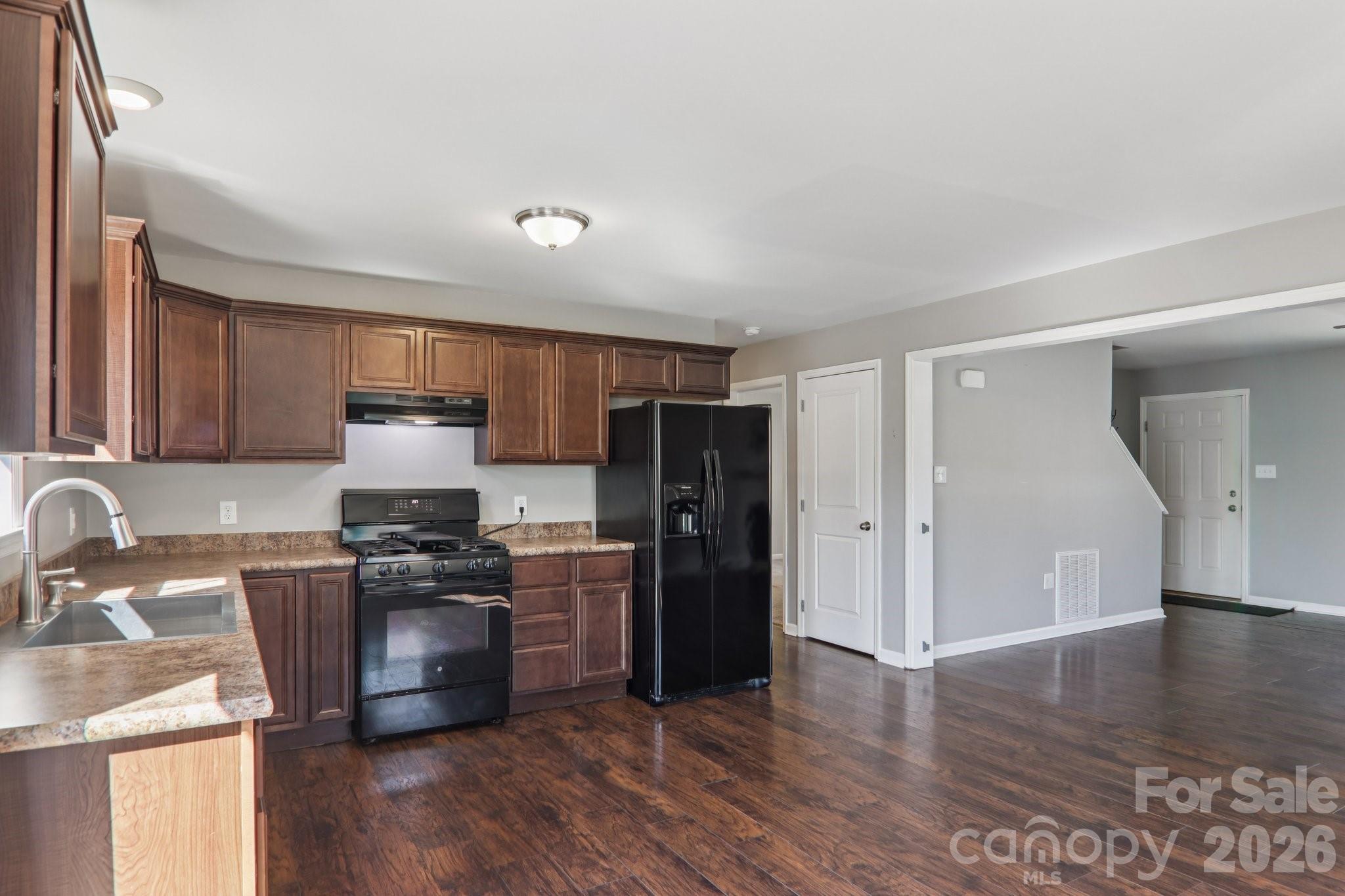 751 Hutch Mountain Road Fletcher, NC 28732 - Photo 19 of 48 a kitchen with stainless steel appliances granite countertop a refrigerator stove top oven and sink