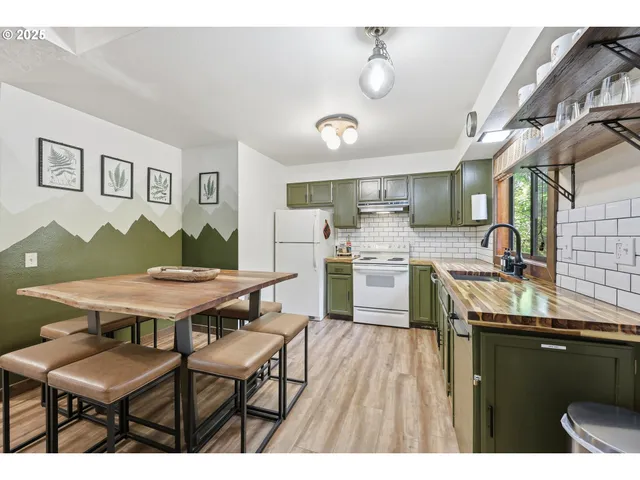 a kitchen with a sink and a stove next to a window