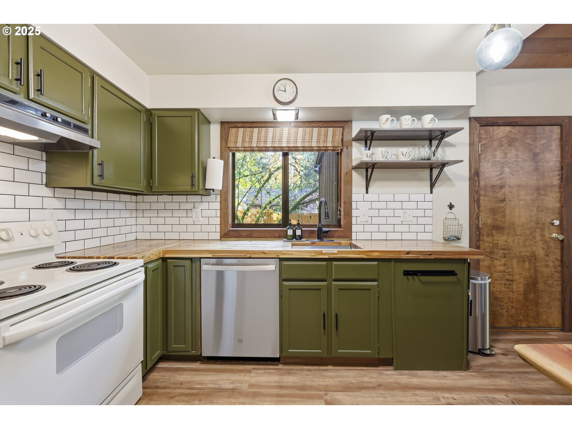 65582 East Timberline Drive Rhododendron, OR 97049 - Photo 12 of 47 a kitchen with a sink and a stove next to a window