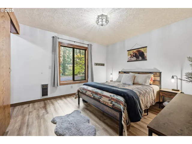 a bedroom with a bed window and a flat screen tv