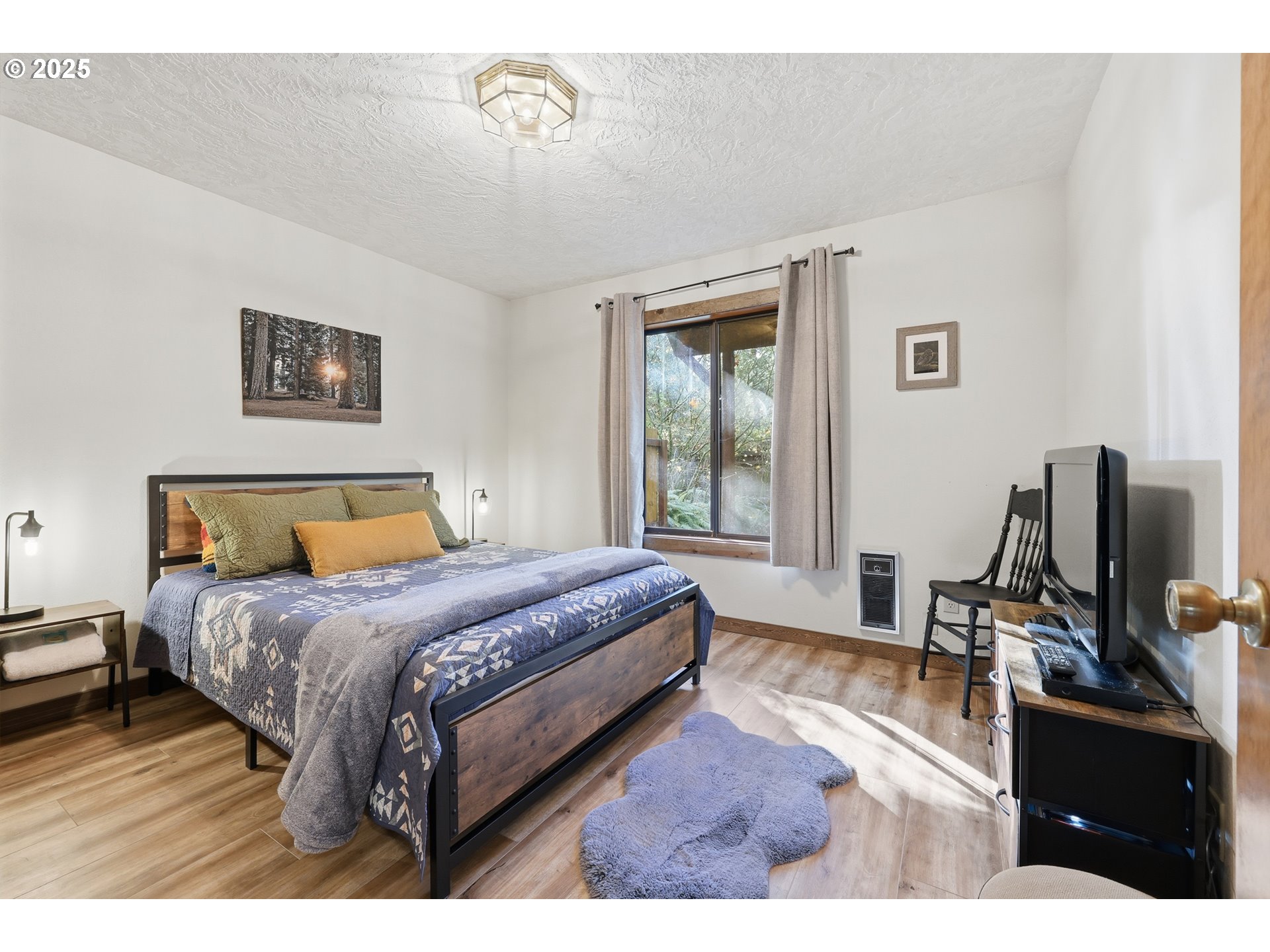65582 East Timberline Drive Rhododendron, OR 97049 - Photo 18 of 47 a bedroom with a bed window and a flat screen tv