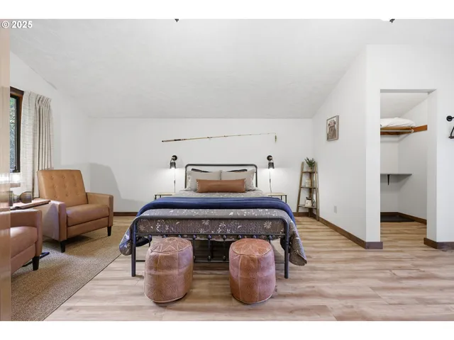 a bedroom with a bed a rug and dresser