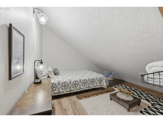 an outdoor sitting area with a couch and wooden floor