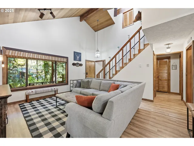 a living room with furniture ceiling fan and a rug