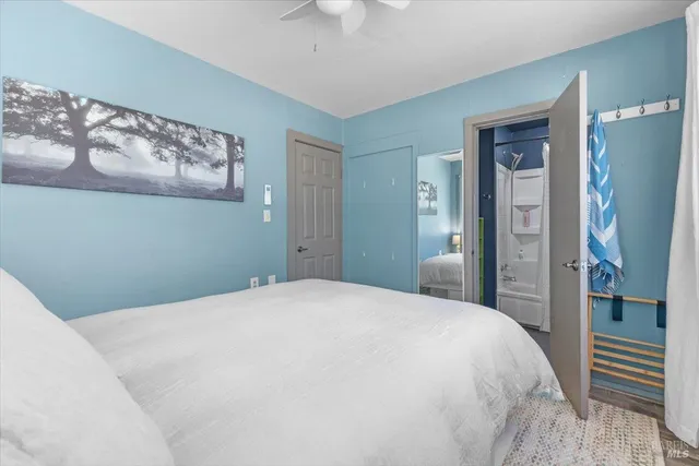 a bedroom with a large bed and a chandelier