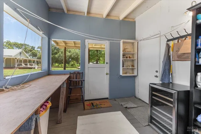 a room with a large window and furniture