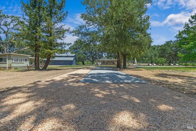 a view of a road with trees and houses