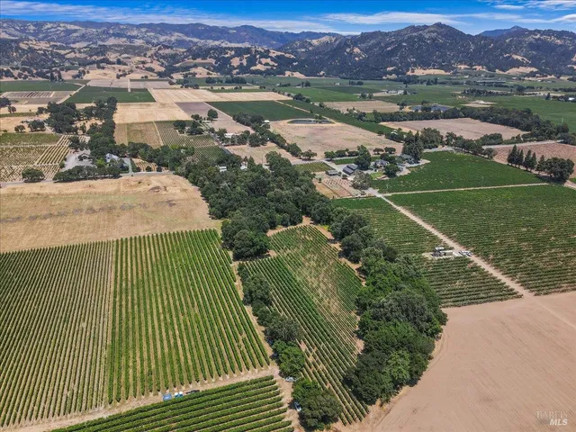 an aerial view of a house with yard and outdoor seating