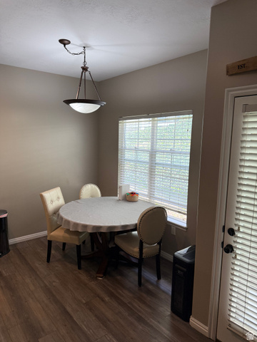 14797 South Chandlerpoint Way Draper, UT 84020 - Photo 13 of 33 Dining area featuring wood-finish flooring, a window with blinds, and a bronze-finish ceiling light fixture