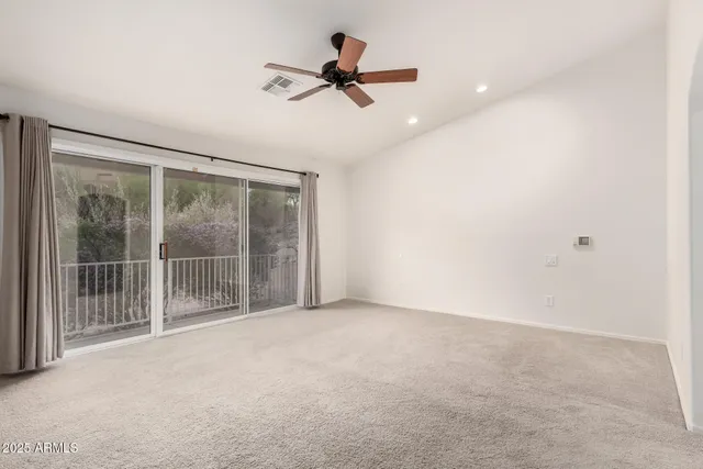 a view of room with a ceiling fan