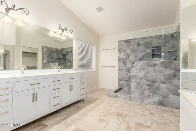 a bathroom with a double vanity sink and a mirror