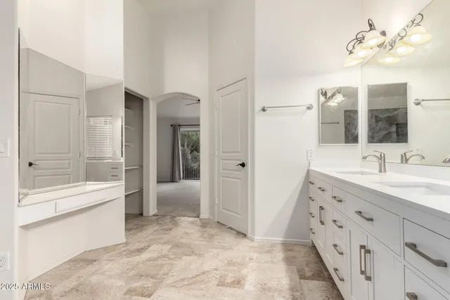 a spacious bathroom with a tub sink and mirror
