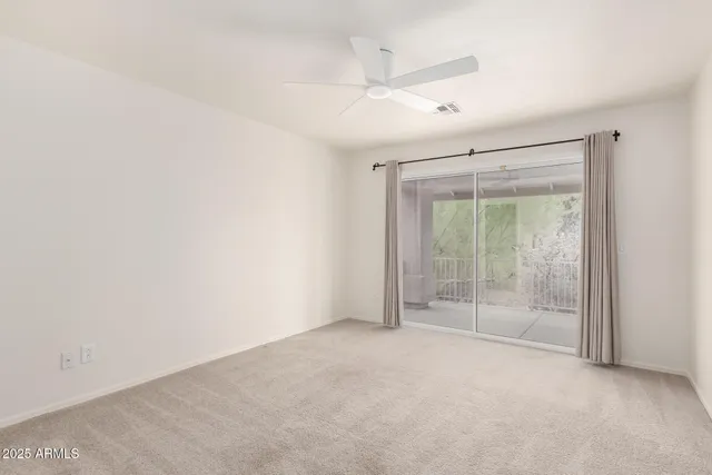 an empty room with sliding glass door and shower