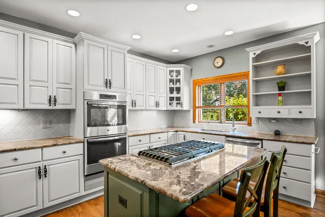a kitchen with a stove a sink and a refrigerator