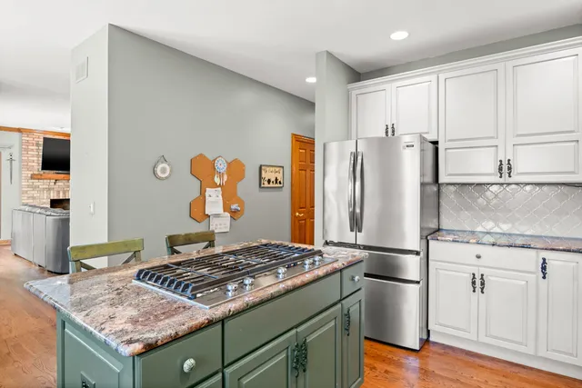 a kitchen with a stove and a refrigerator