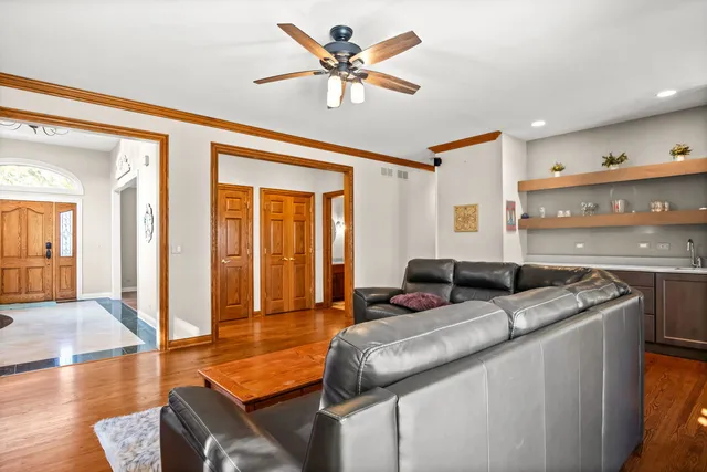 a living room with stainless steel appliances granite countertop furniture a couch and a view of kitchen