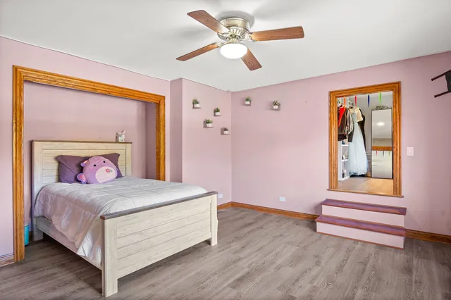 a bedroom with a bed and a painting on the wall