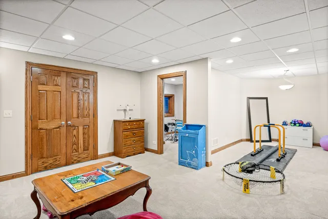 a living room with furniture and a large mirror