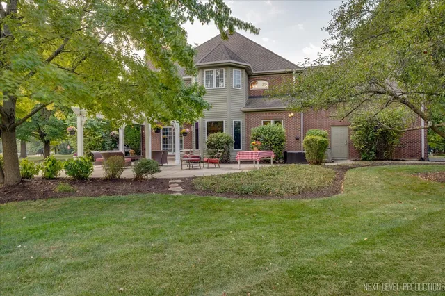 a view of a bench in the garden near a lake