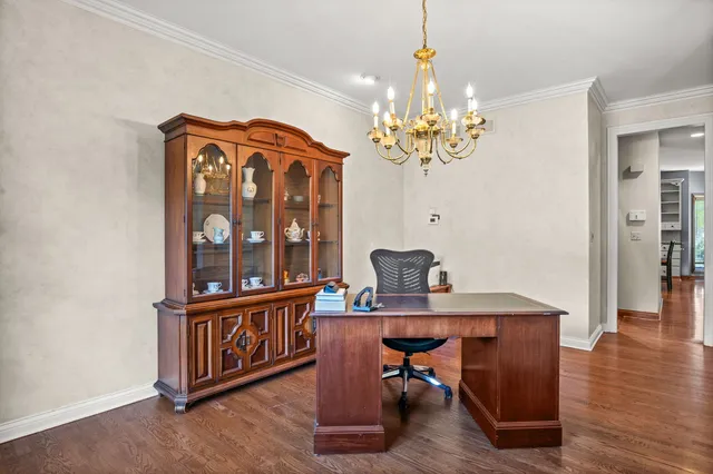 a view of a dining room with furniture wooden floor and chandelier