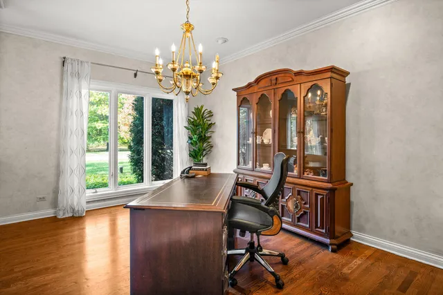 a view of a room with furniture wooden floor and chandelier