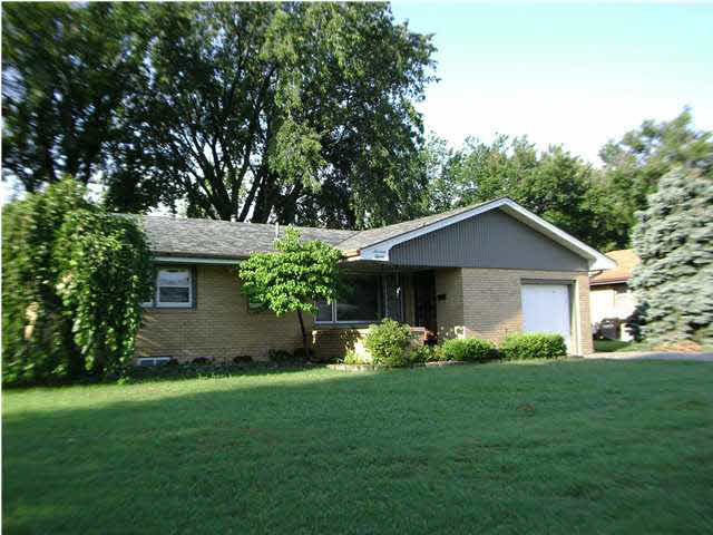 Front of home with mature trees