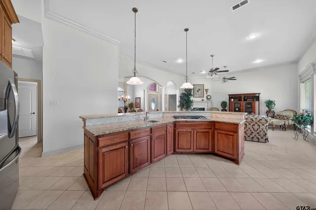 a kitchen with stainless steel appliances granite countertop a sink a stove and a wooden floors