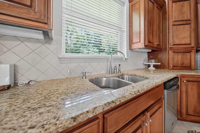 a kitchen with a sink cabinets and window