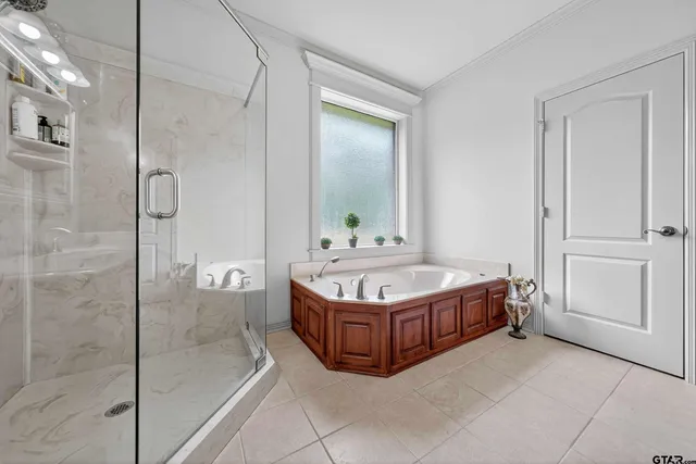 a bathroom with a tub shower and mirror