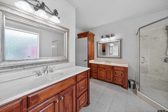 a spacious bathroom with double vanity sink and a mirror