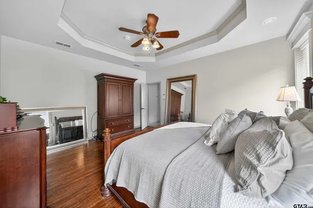a bedroom with bed and a chandelier