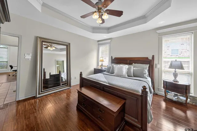 a bedroom with a bed and a chandelier