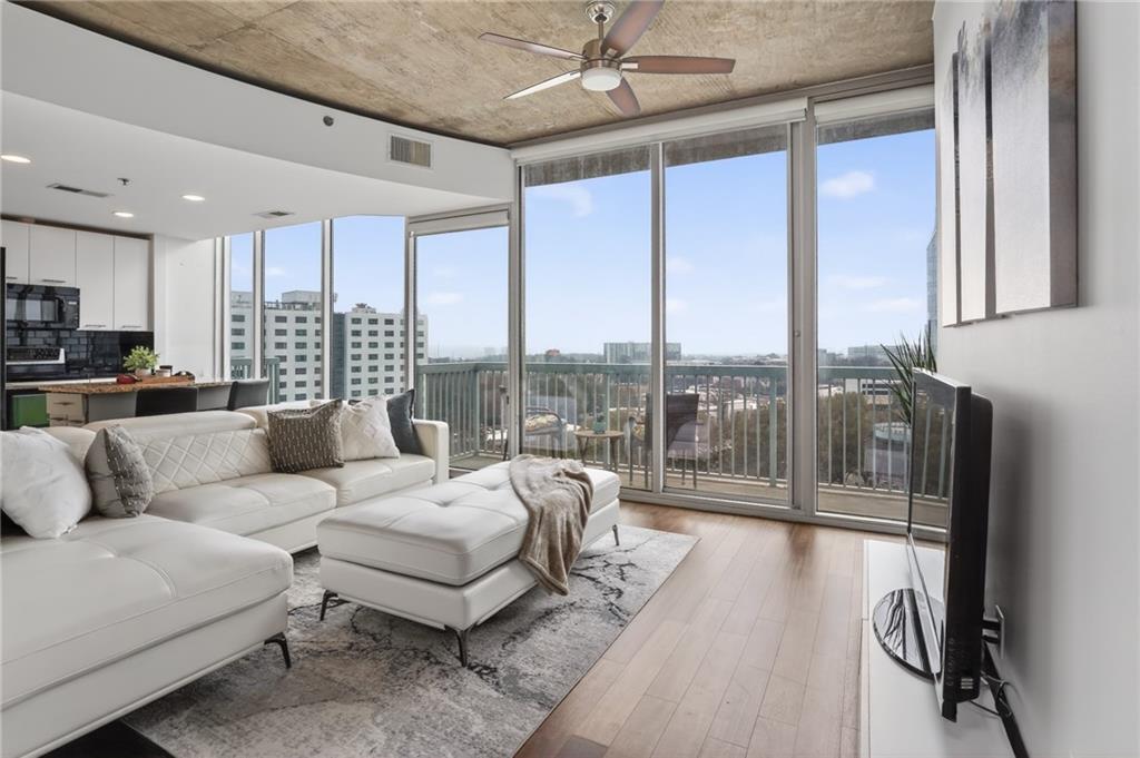 3324 Peachtree Road Northeast, Unit 1312 Atlanta, GA 30326 - Photo 13 of 23 a living room with furniture and a large window