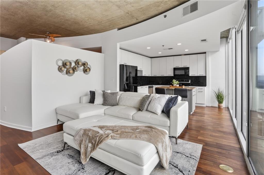 3324 Peachtree Road Northeast, Unit 1312 Atlanta, GA 30326 - Photo 14 of 23 a living room with furniture and a wooden floor