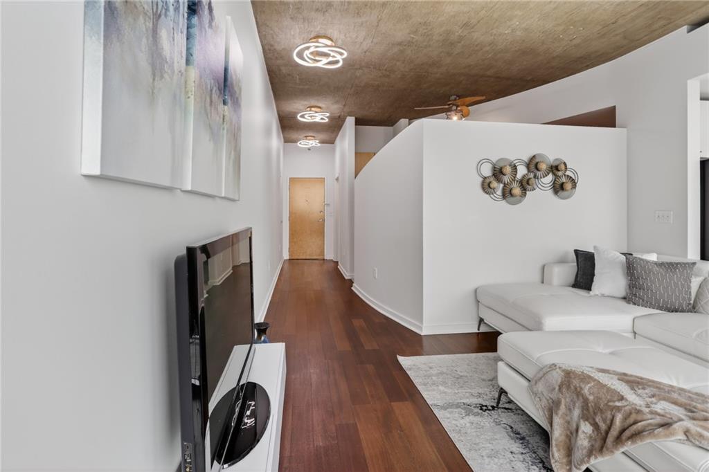 3324 Peachtree Road Northeast, Unit 1312 Atlanta, GA 30326 - Photo 15 of 23 a living room with furniture and a wooden floor