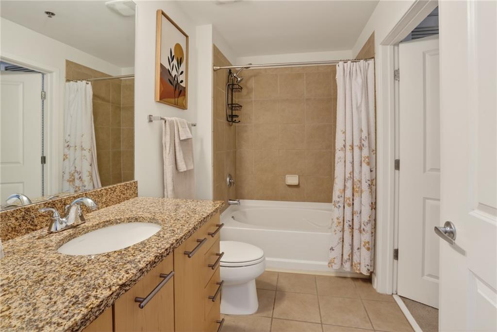 3324 Peachtree Road Northeast, Unit 1312 Atlanta, GA 30326 - Photo 22 of 23 a bathroom with a granite countertop sink toilet and shower