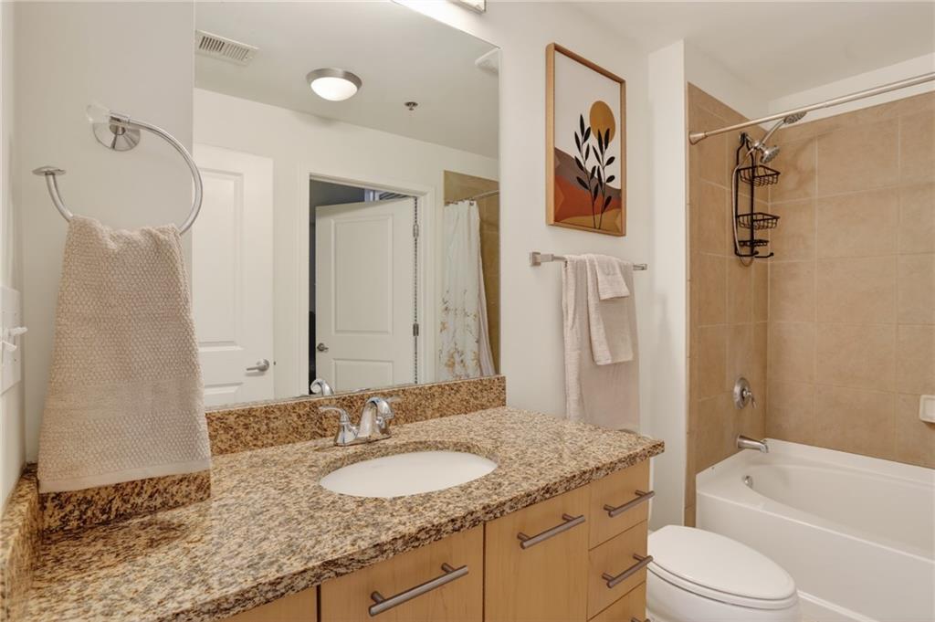 3324 Peachtree Road Northeast, Unit 1312 Atlanta, GA 30326 - Photo 23 of 23 a bathroom with a granite countertop sink toilet and shower