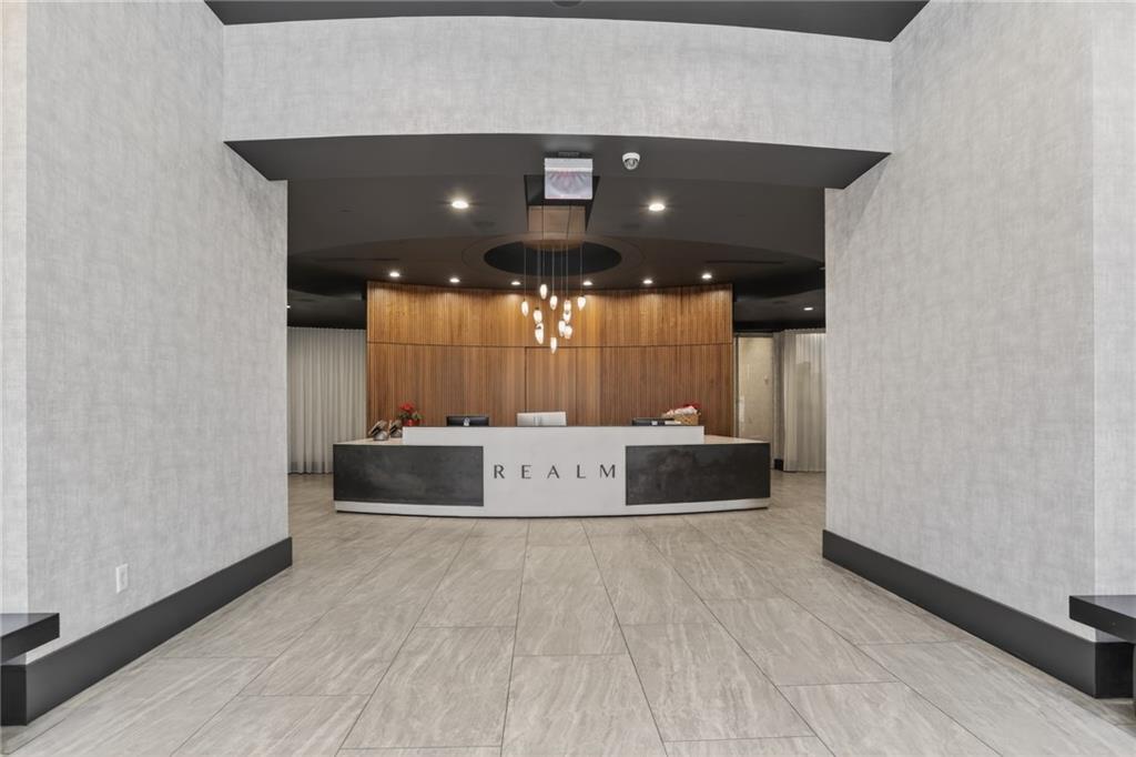 3324 Peachtree Road Northeast, Unit 1312 Atlanta, GA 30326 - Photo 3 of 23 a large white building with a sink and a large mirror next to a window