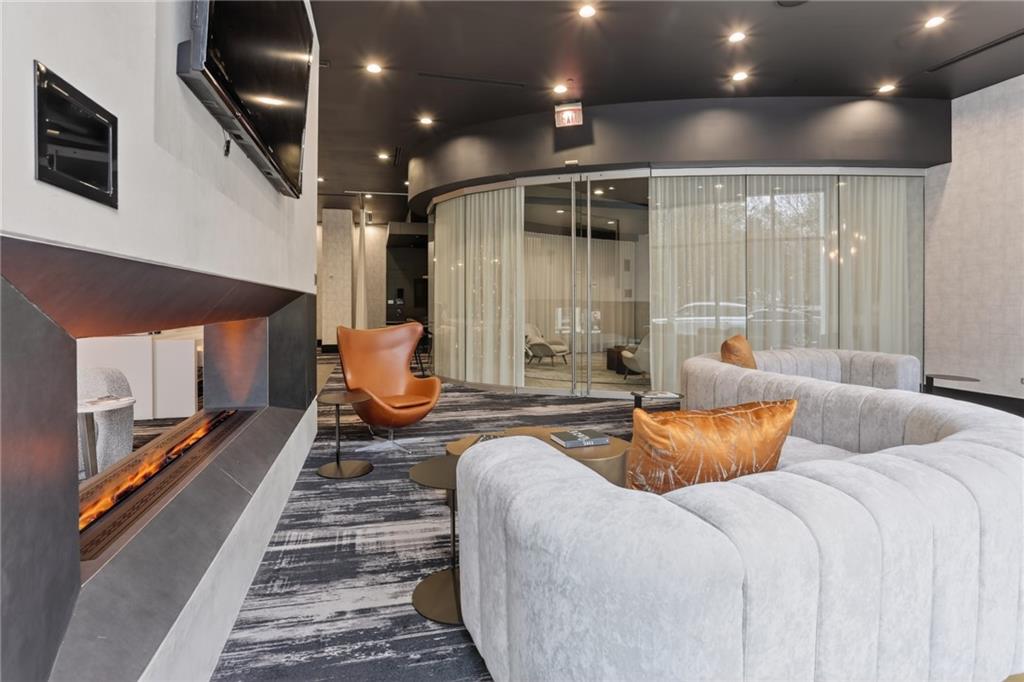 3324 Peachtree Road Northeast, Unit 1312 Atlanta, GA 30326 - Photo 5 of 23 a living room with furniture and a fireplace