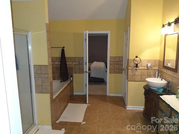 a bathroom with a tub and shower