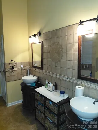 a bedroom with a bed and a lamp on table