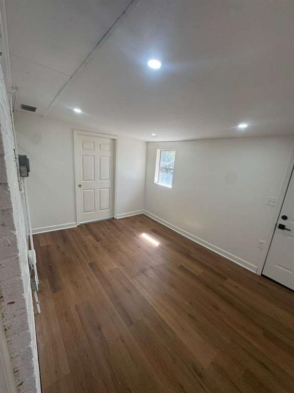 3005 Belvedere Lane Decatur, GA 30032 - Photo 5 of 16 an empty room with wooden floor and windows
